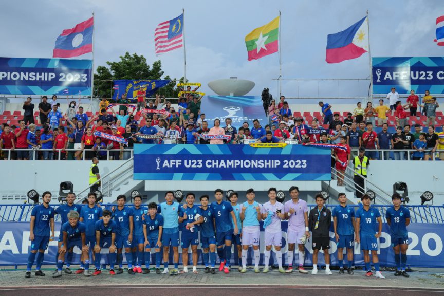 Footballers lined up on the pitch beneath national flags at the AFF U23 Championship 2023